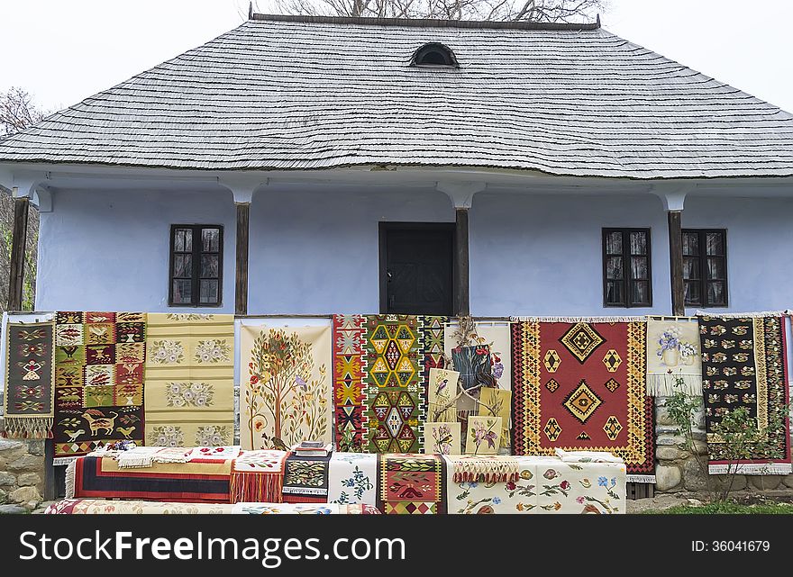 Traditional house with carpets exposed in front.