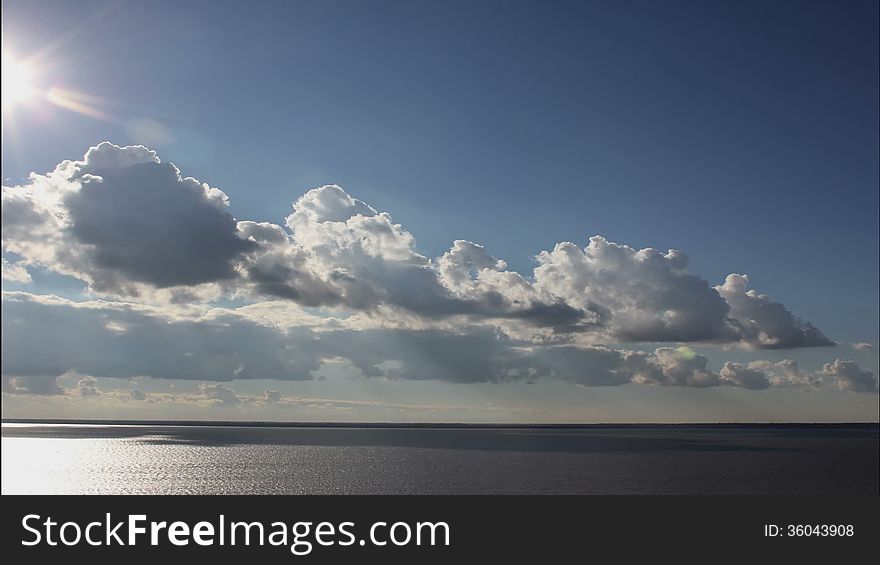 Drifting Cloud, cloud formation of different cloud types in a blue sky, at dusk, time lapse. Drifting Cloud, cloud formation of different cloud types in a blue sky, at dusk, time lapse