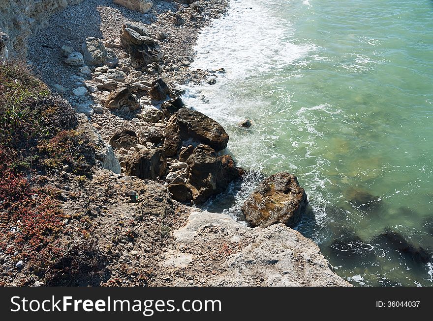 Ukraine, peninsula of Crimea, Sea coast on the Black Sea, large and small pebbles, large boulders, sea waves. Ukraine, peninsula of Crimea, Sea coast on the Black Sea, large and small pebbles, large boulders, sea waves