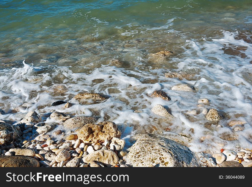 Ukraine, peninsula of Crimea, Sea coast on the Black Sea, large and small pebbles, large boulders, sea waves. Ukraine, peninsula of Crimea, Sea coast on the Black Sea, large and small pebbles, large boulders, sea waves