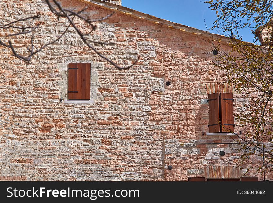 The old Church of red bricks in the mountains of Italy summer day. The old Church of red bricks in the mountains of Italy summer day