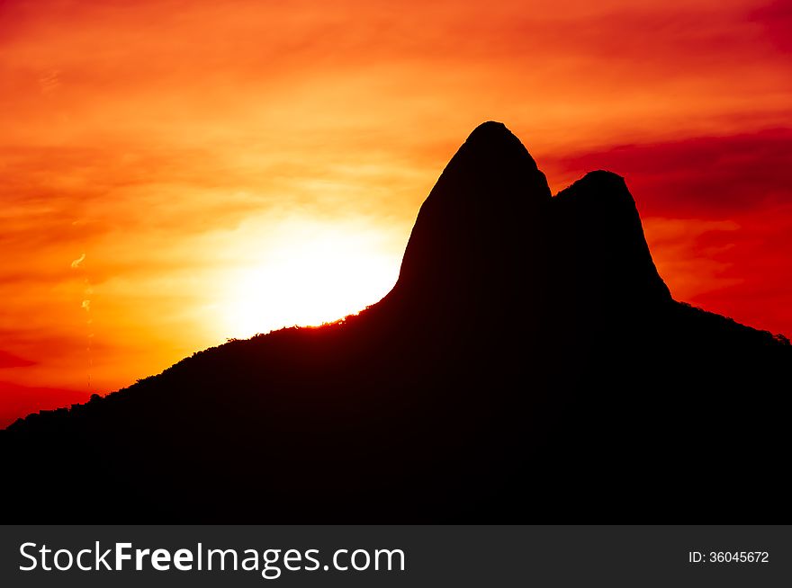 Beautiful Red Sunset Behind Mountains in Ipanema Beach, Rio de Janeiro, Brazil.