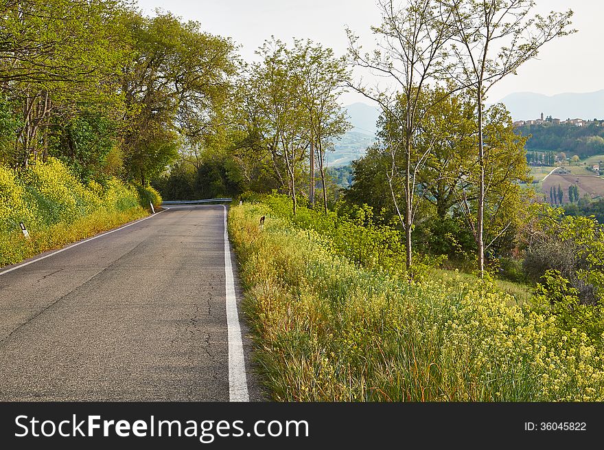 Turn mountain road among the green trees in the mountains of Italy. Turn mountain road among the green trees in the mountains of Italy