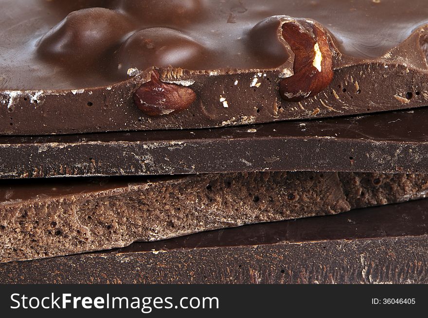 A closeup of pieces of chocolate (dark, milk).