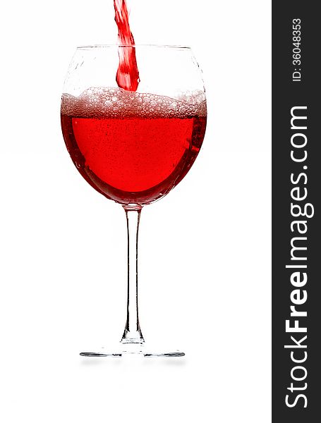 Glass with pouring red wine. Glass with pouring red wine