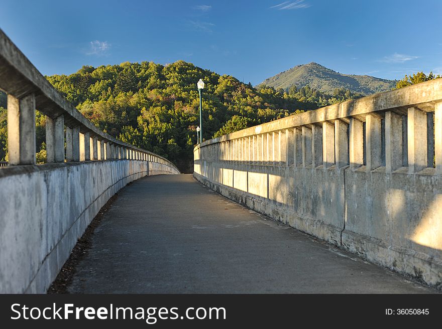 Concrete bridge with light poles over river