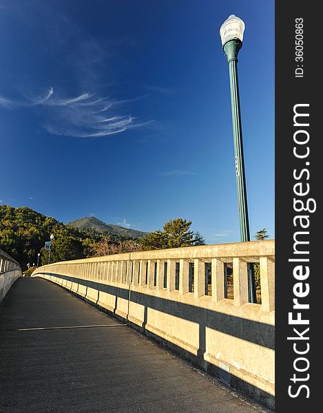 Old fashion bridge over a river with a light pole. Old fashion bridge over a river with a light pole