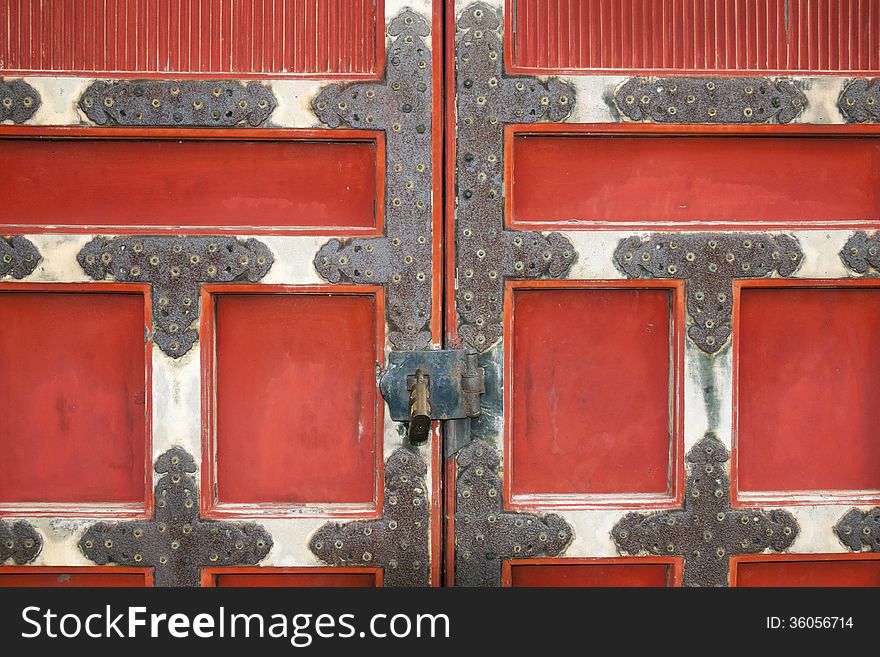 Ancient wooden temple door locked by padlock. Ancient wooden temple door locked by padlock
