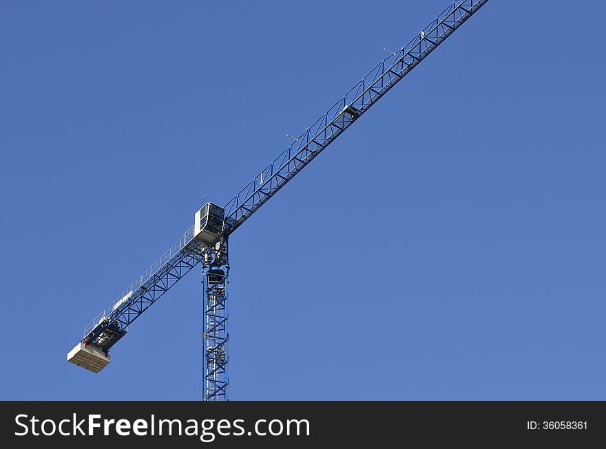 The tower crane in blue background. The tower crane in blue background