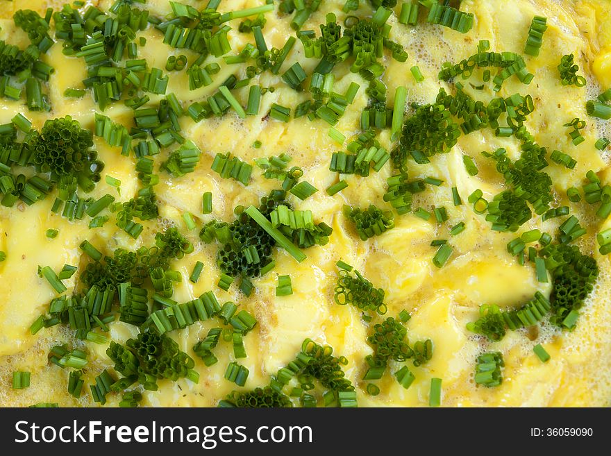 Omelet scrambled eggs with chives and herbs in a close up view