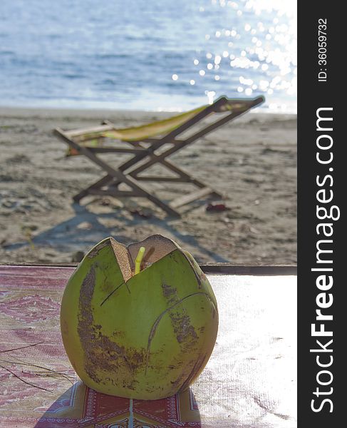 Coconut Drink With Strobe On The Beach