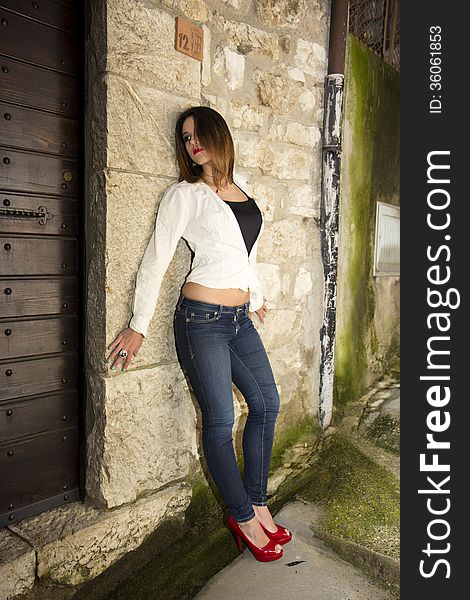 Beautiful model with red lips in red heels posing. Beautiful model with red lips in red heels posing