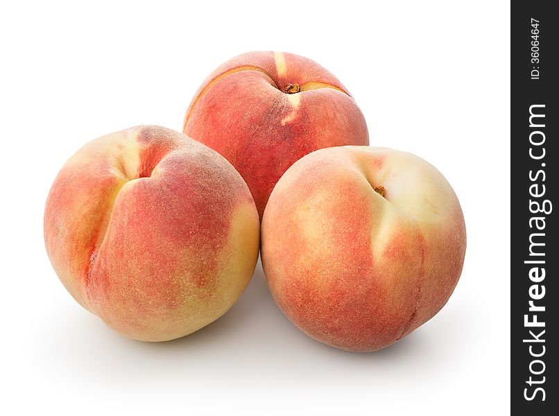 Three beautiful peaches isolated on a white background