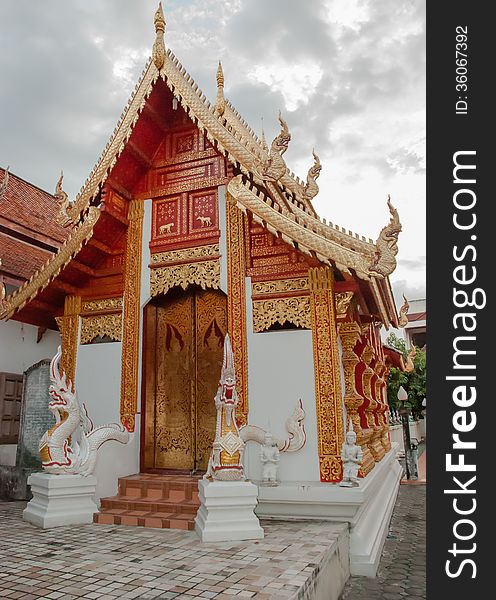 A red Buddhist temple roof in Chiang Mai, Thailand.