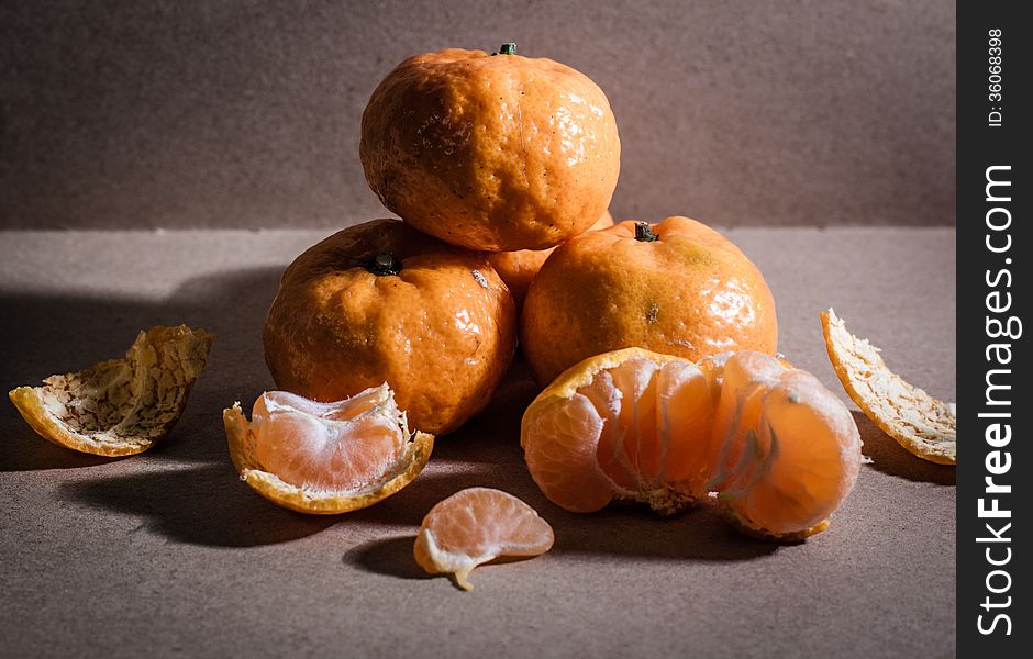 Fresh oranges against dark background.