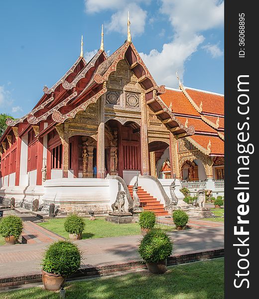 A red Buddhist temple roof in Chiang Mai, Thailand.