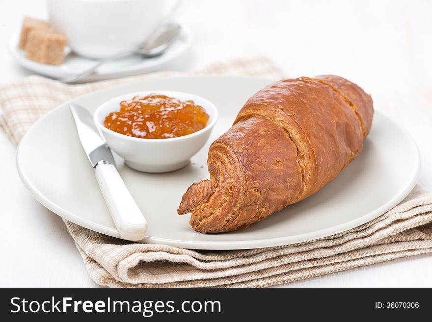 Fresh croissant with jam for breakfast close-up