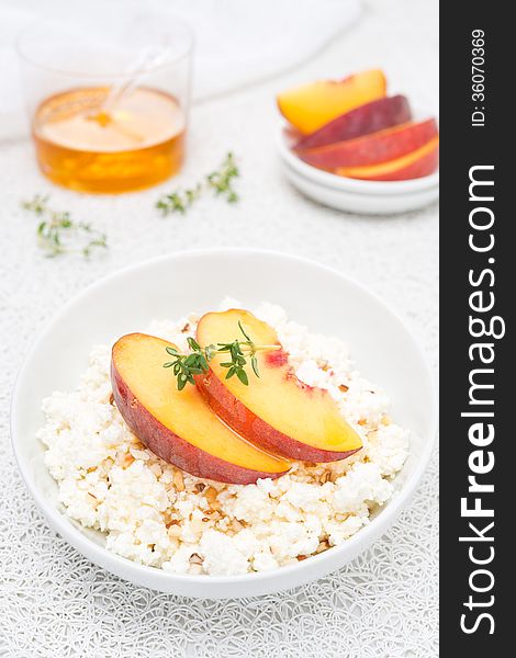 Fresh homemade cottage cheese with honey, walnuts and peaches