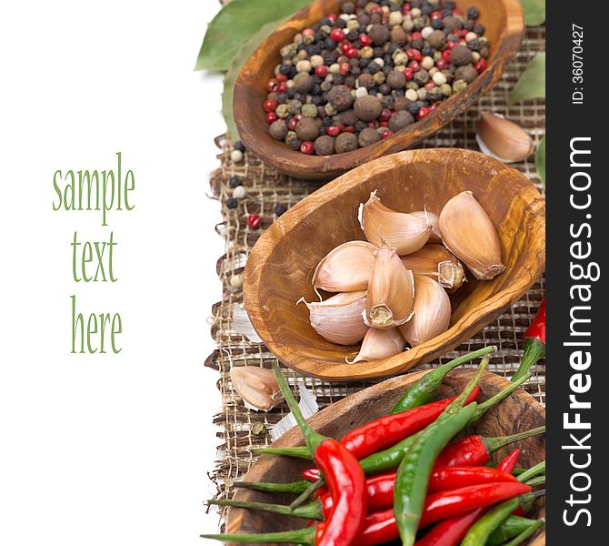 Garlic and spices in bowls, isolated