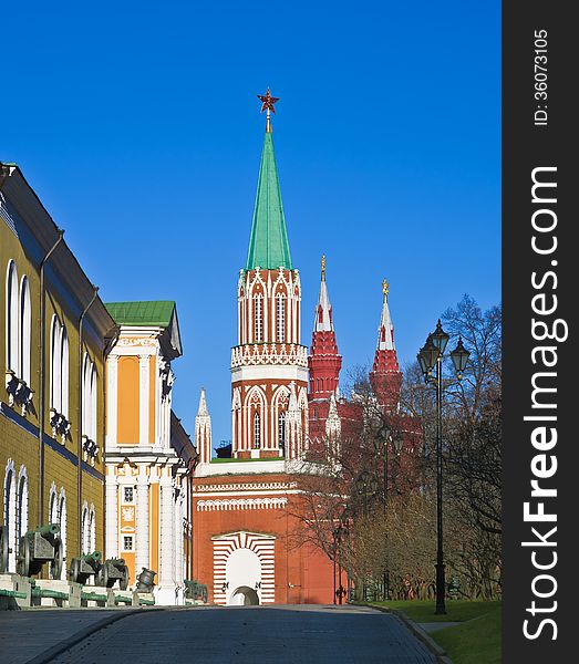 The Arsenal and the St. Nicholas (Nikolskaya) Tower in Moscow Kremlin. Towers of State Historical Museum in the background. Moscow, Russia. The Arsenal and the St. Nicholas (Nikolskaya) Tower in Moscow Kremlin. Towers of State Historical Museum in the background. Moscow, Russia