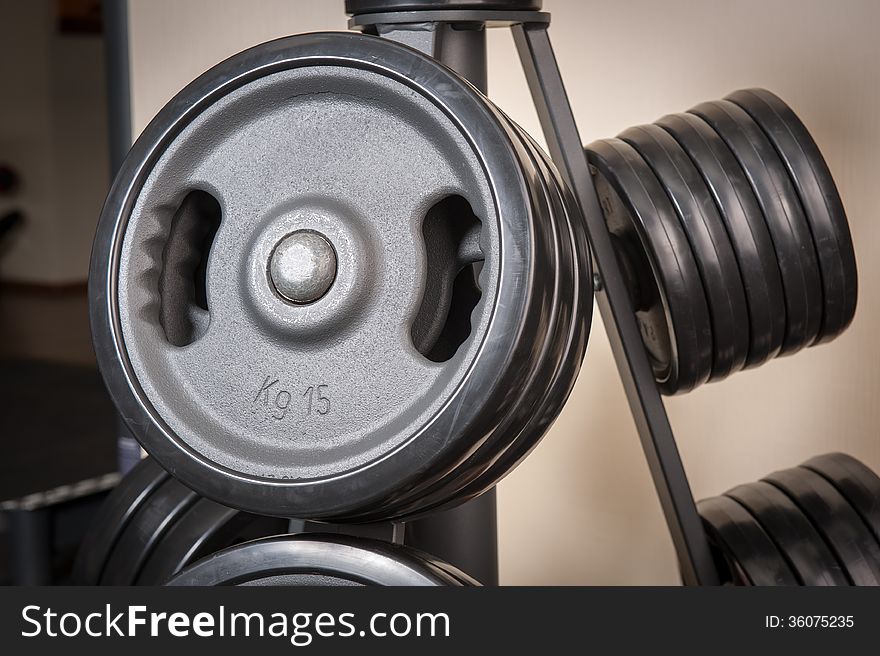 Barbell plates holder rack in the gym. Barbell plates holder rack in the gym