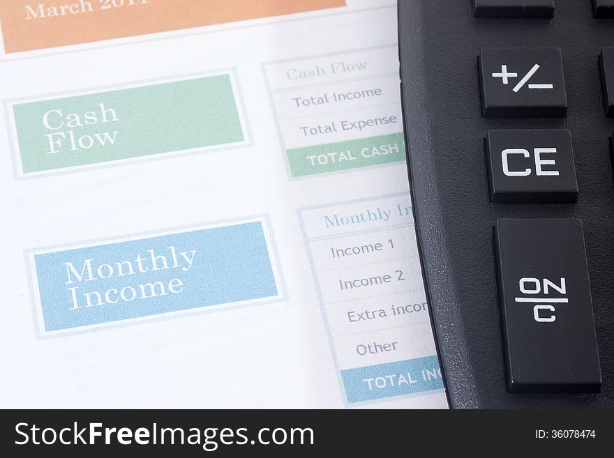 Family monthly budget planner estimate with a black calculator. Family monthly budget planner estimate with a black calculator