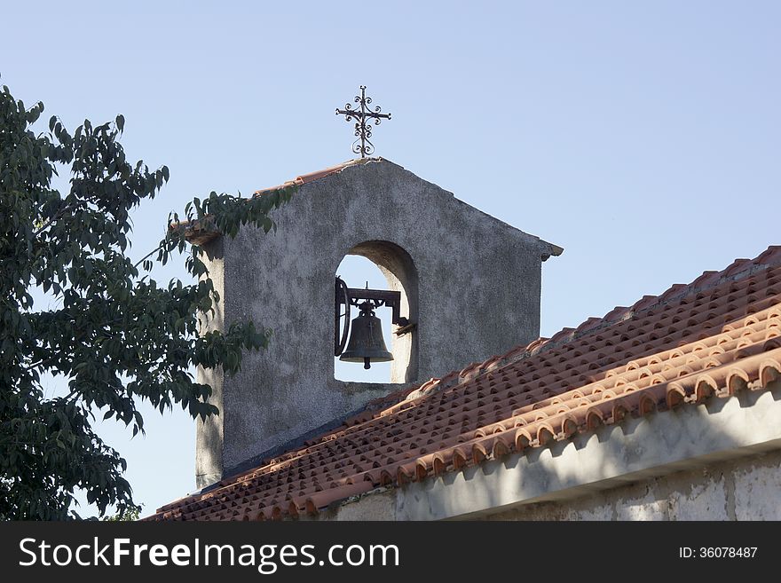 Bell tower with a cross on a church in Croatia