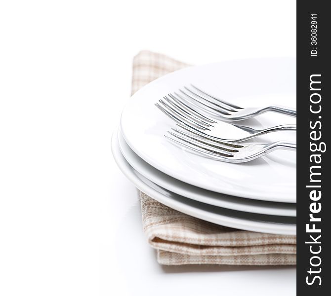 Tableware for dinner - plates and forks, isolated on white