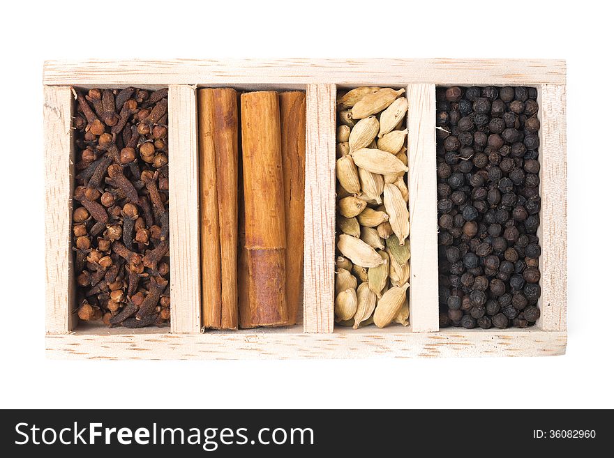 Wooden box with different kinds of spices, isolated on white. Wooden box with different kinds of spices, isolated on white