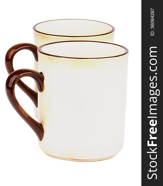 Pair of Beige Tea Cups with Brown Handles isolated on white background. Pair of Beige Tea Cups with Brown Handles isolated on white background