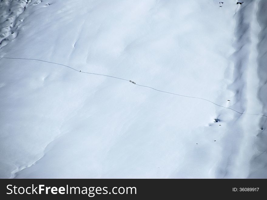 A group of tourists climbs mountains glaciert, Switzerland.