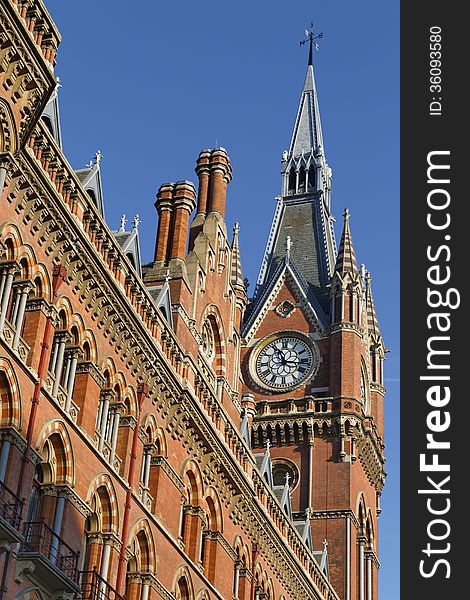 Image taken of a victorian clock tower against blue sky, kings cross, London, England