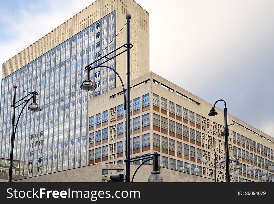 Wide angle image of office Windows and lamp posts and sky background taken in London, england