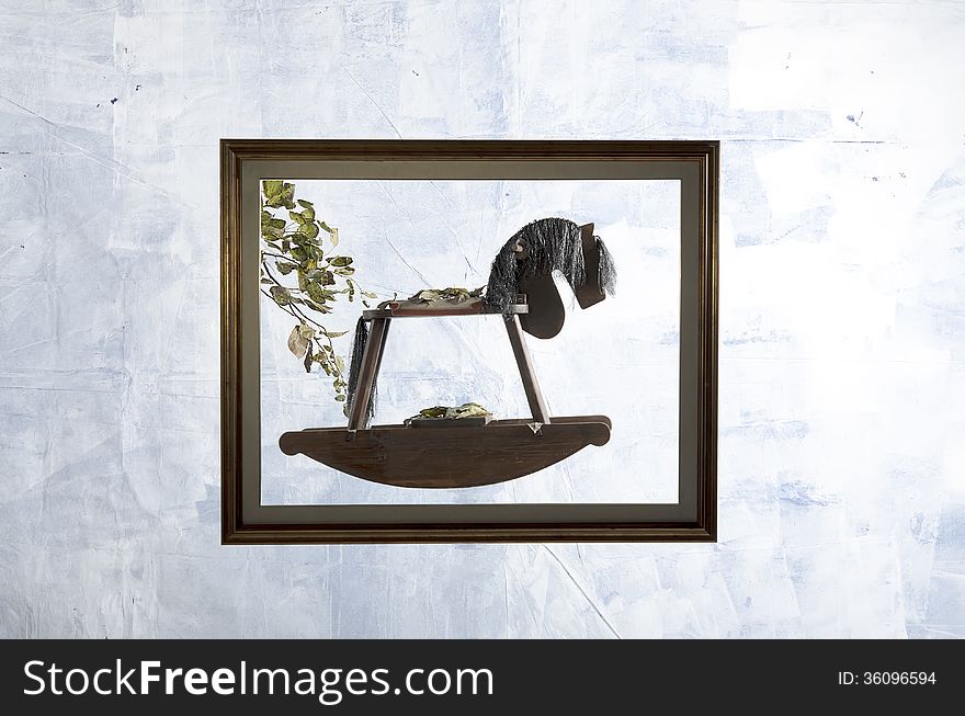 Rocking horse in a frame on the white background stop time in the autumn season. Rocking horse in a frame on the white background stop time in the autumn season.