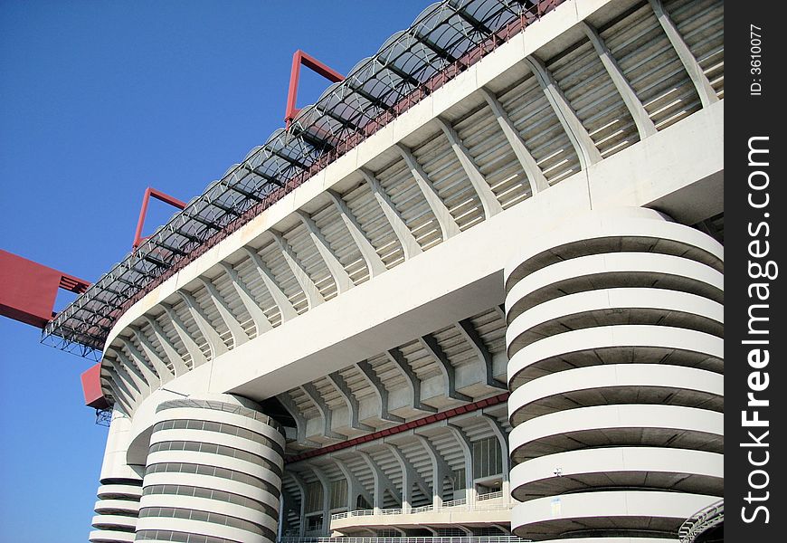 A part of the San Siro stadium in Milan under a blue sky. A part of the San Siro stadium in Milan under a blue sky