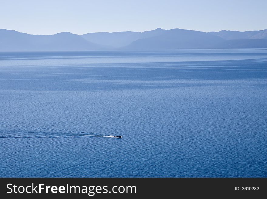 one lone motorboat zipping across Lake Tahoe. one lone motorboat zipping across Lake Tahoe