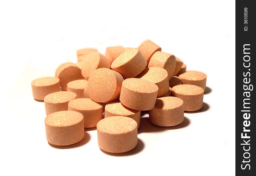 Macro pile of orange chewable vitamin tablets. Macro pile of orange chewable vitamin tablets