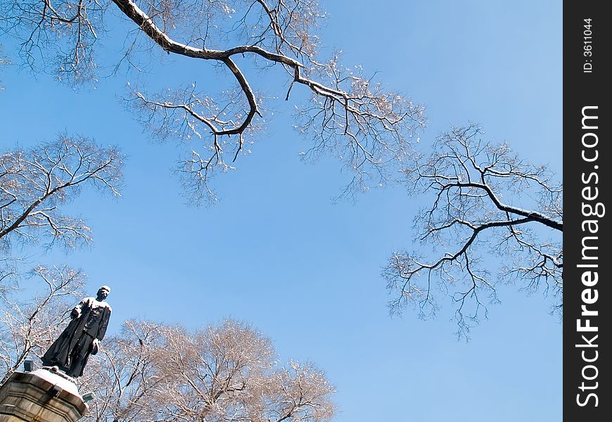 Russian revolutionaries Sergey Lazo statue in russian city Vladivostok against the snow trees and blue sky