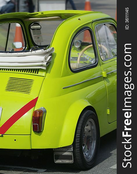 Small, classic, green, Italian convertible car with rear engine as seen from behind. Small, classic, green, Italian convertible car with rear engine as seen from behind