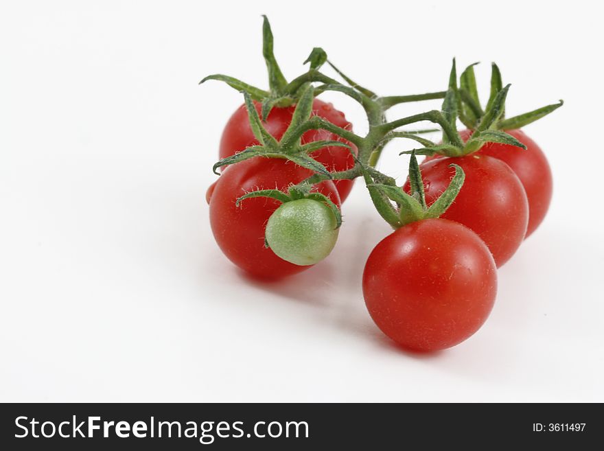 Five tiny delicious tomatoes  attached to a little one. Five tiny delicious tomatoes  attached to a little one.