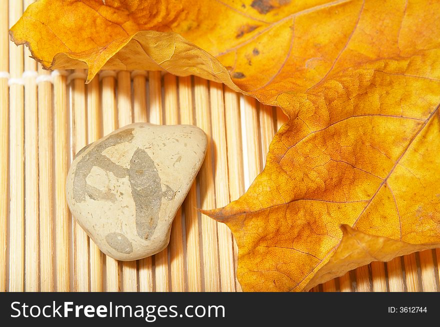flat stone and over autumn leaf. flat stone and over autumn leaf