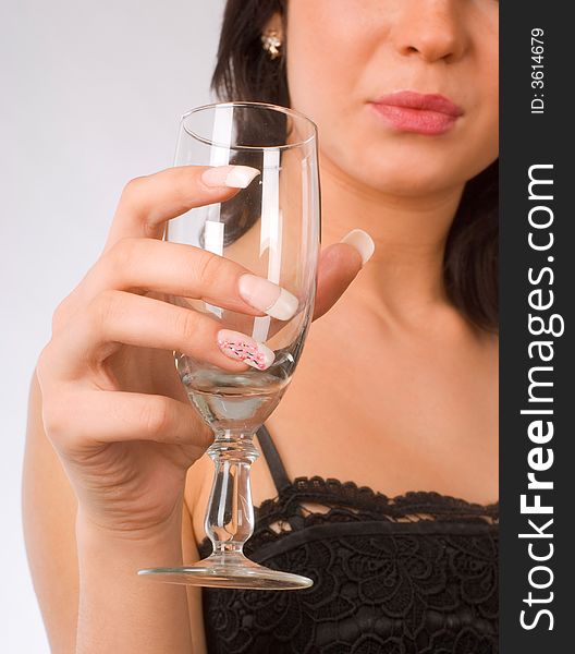 Brunette girl with glass of wine on the white background