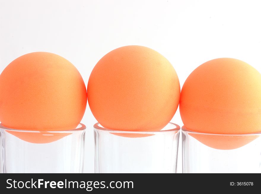 Three orange balls and glass. Three orange balls and glass