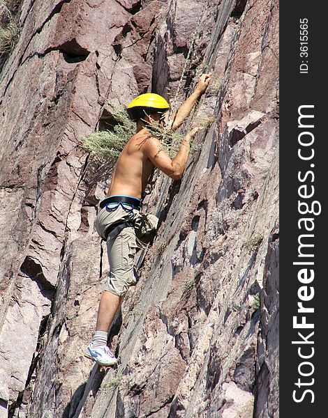 Climber climbs on a rock