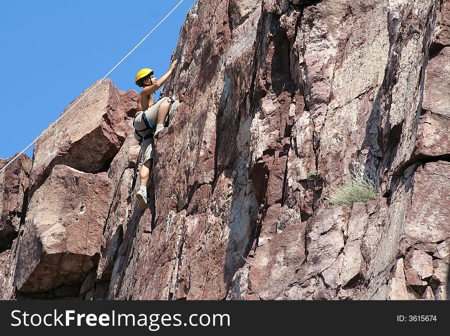 Climber climbs on a rock