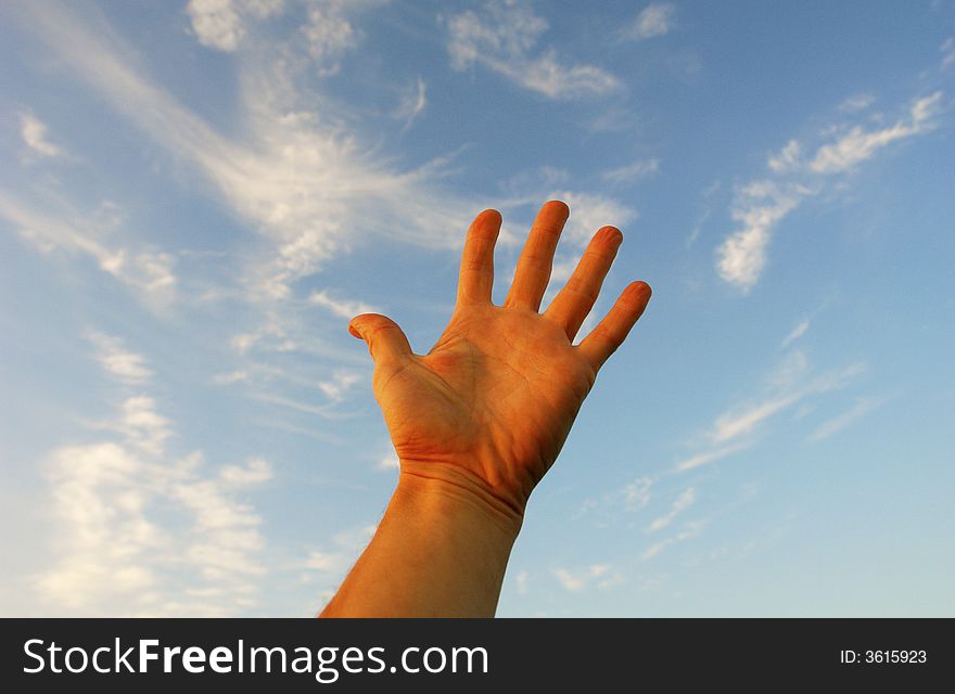 Hand on a background of clouds