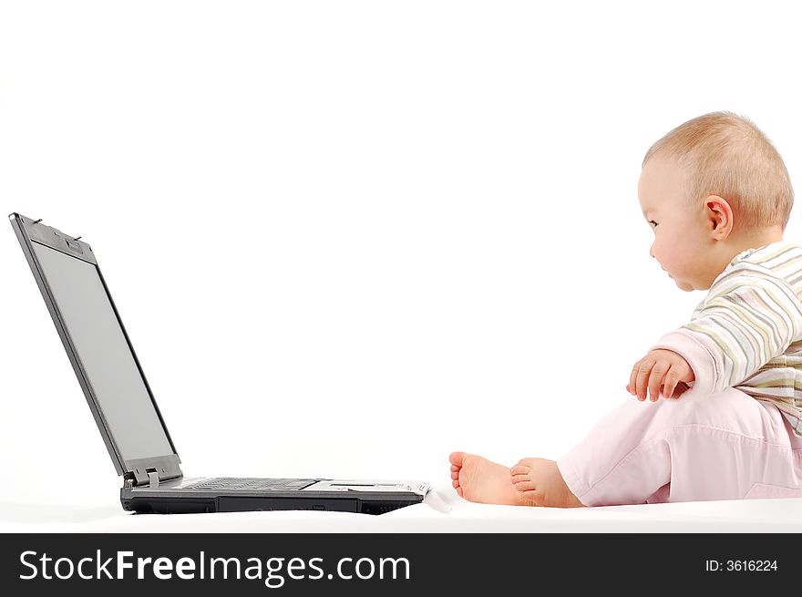 Sweet happy baby girl having fun with laptop on white background. Sweet happy baby girl having fun with laptop on white background