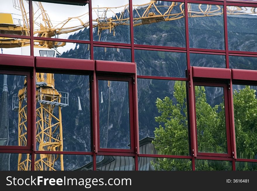 Reflection of crane in a façade,. Reflection of crane in a façade,