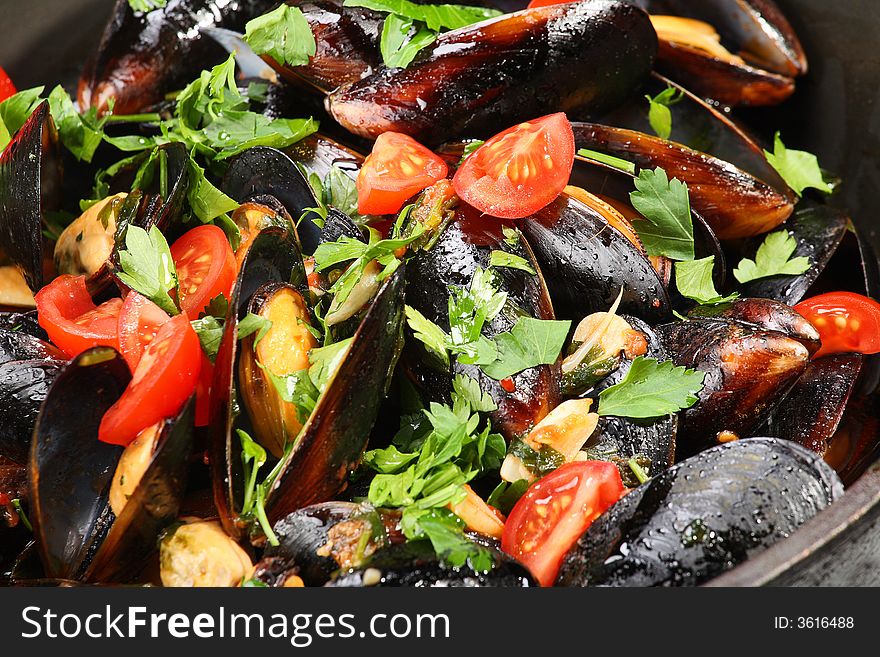 Mussel stew (ragout) with garlic and cherry tomatoes
