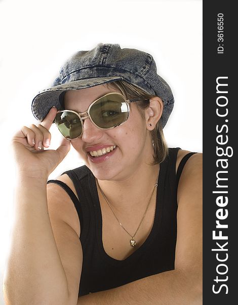 Portrait of a young attractive woman with glasses and cap